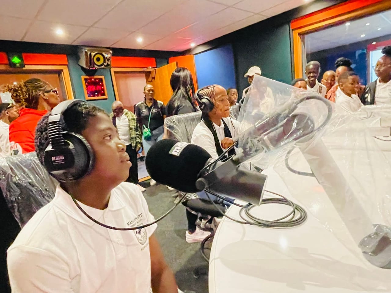 Learners wearing headphones in the Kouga FM studio